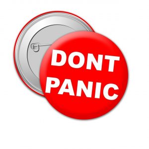 a badge that reads don't panic